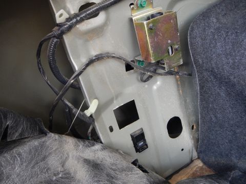 2002 Mercury Grand Marquis - Close-up of car trunk wiring and a switch, likely part of an aftermarket installation.