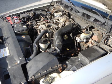 2002 Mercury Grand Marquis - The engine bay of a 2002 Mercury Grand Marquis is visible, with the hood open.