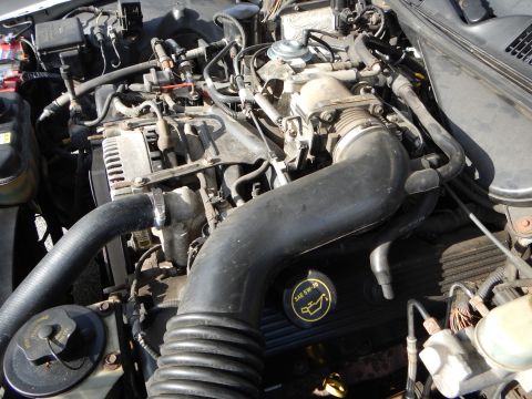 2002 Mercury Grand Marquis - Close-up view of a vehicle's engine bay, showing various components and hoses.