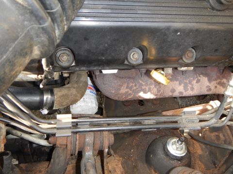 2002 Mercury Grand Marquis - Close-up view of engine components including an oil filter and exhaust manifold.