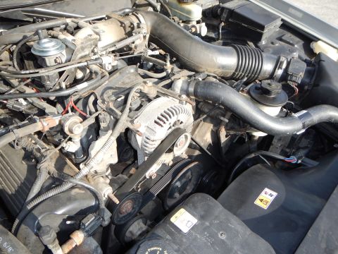 2002 Mercury Grand Marquis - Close-up view of a car's engine bay, showing various components and wiring.
