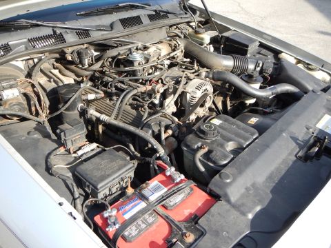2002 Mercury Grand Marquis - The engine bay of a 2002 Mercury Grand Marquis shows its V8 engine, battery, and associated components.
