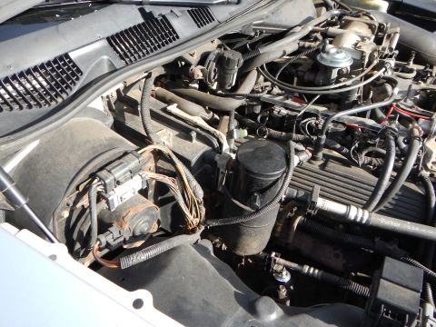 2002 Mercury Grand Marquis - A close-up view of the engine compartment, showing various mechanical parts and wiring harnesses.