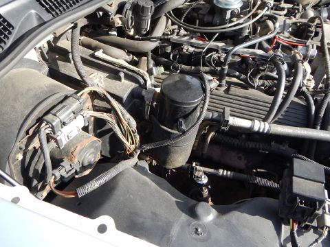 2002 Mercury Grand Marquis - Close-up view of a vehicle's engine bay, showing various components and wiring.