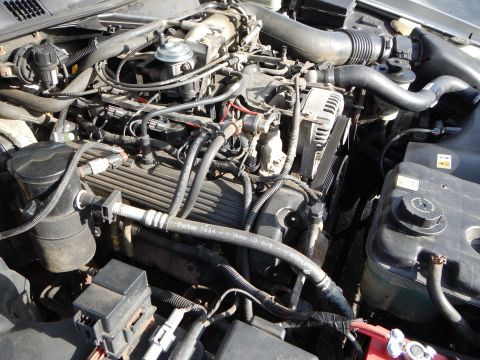 2002 Mercury Grand Marquis - Close-up view of a vehicle's engine bay, showing various components and hoses.