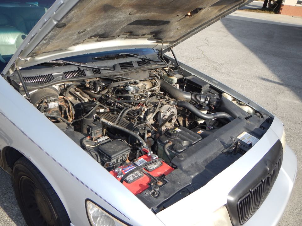 Silver 2002 Mercury Grand Marquis engine bay with hood open