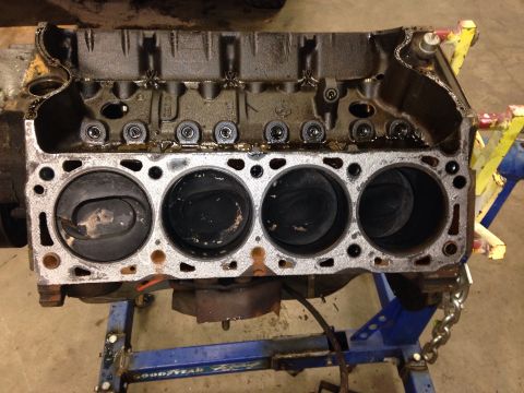 1993 Ford Bronco - Engine block on an engine stand, showing four cylinders and internal components.