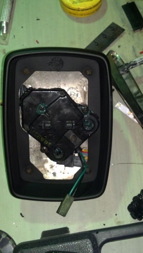 1985 Mercury Grand Marquis - Disassembled car mirror assembly showing internal components and wiring, likely for repair or replacement.