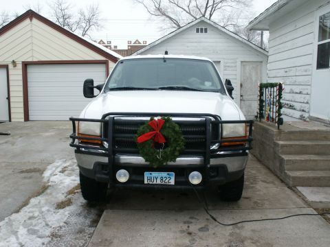 2000 Ford F-250 - This 2000 Ford F-250 is seen from the front, decorated for the holidays with a wreath on its grille and a license plate reading HUY 822.
