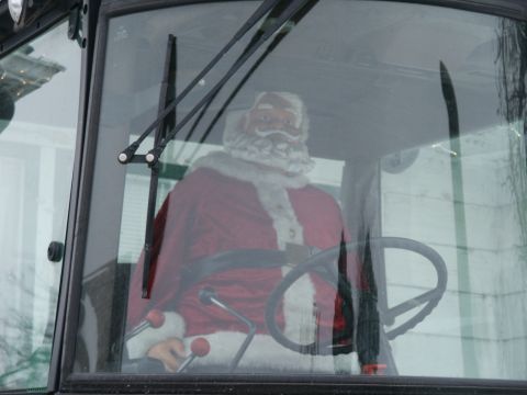 1966 Ford Bronco - A Santa Claus figure sits behind the steering wheel of a vehicle, seen through the windshield.