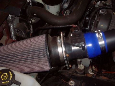 2004 Ford Crown Victoria - Close-up of an aftermarket engine air intake system, including a K&N air filter and MAF sensor.