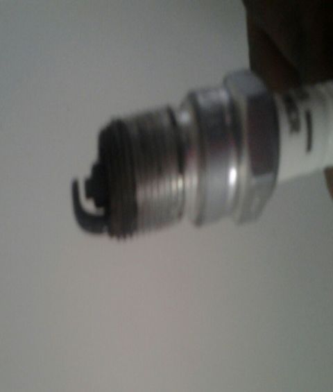 2004 Ford Crown Victoria - A spark plug is shown, a critical component for igniting fuel in an engine.