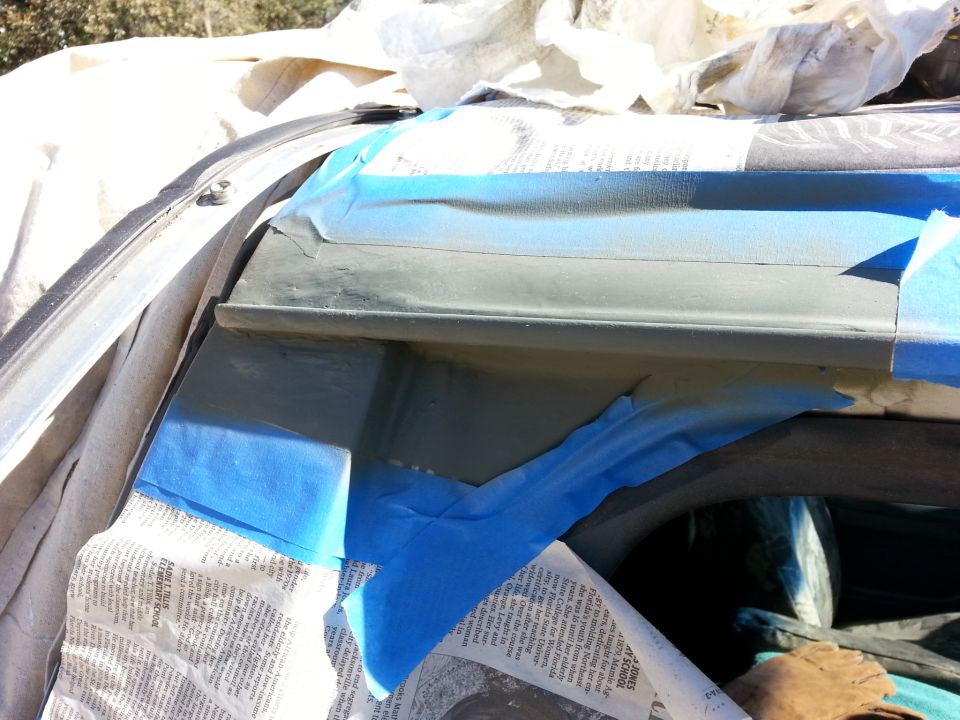 Close-up of masked-off vehicle drip rail being painted