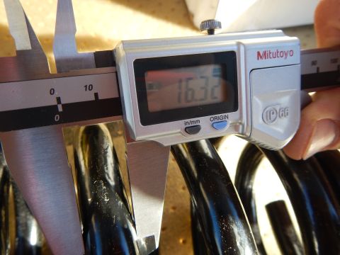 2003 Ford Crown Victoria - Mitutoyo digital caliper shows 16.32 while clamped on the wire of a black coil spring.