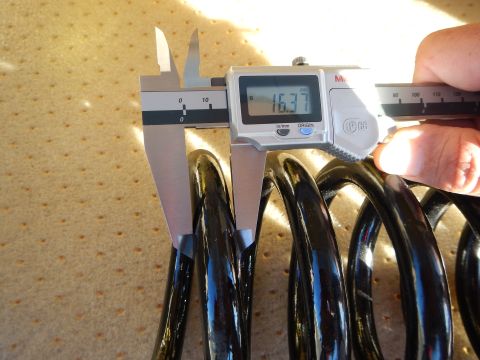 2003 Ford Crown Victoria - Mitutoyo digital caliper reading 16.37 is held against a black coil spring on a perforated tan pad.