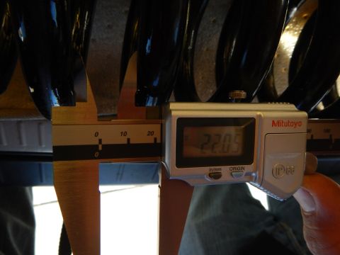 2003 Ford Crown Victoria - Mitutoyo digital caliper showing 22.05 measures the coil spacing of a black coil spring from below.