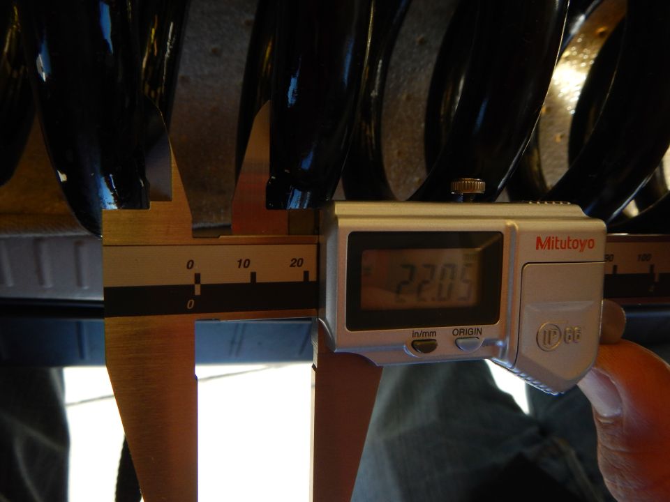 Mitutoyo digital caliper reading 22.05 measuring black coil spring coil gap