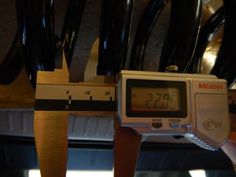 2003 Ford Crown Victoria - Mitutoyo digital caliper reading 22.05 measures a black coil spring, with a plastic liner and tire visible below.