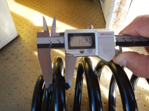2003 Ford Crown Victoria - Mitutoyo digital caliper reading 15.23 is held against a black coil spring on a perforated tan pad.