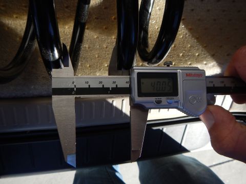 2003 Ford Crown Victoria - Mitutoyo digital caliper showing 40.05 measures the coil gap of a black coil spring over a bed liner.