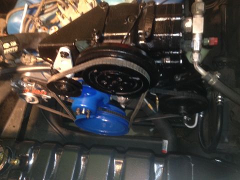 1978 Ford Bronco - The engine bay features a blue power steering pump and various belts and hoses.
