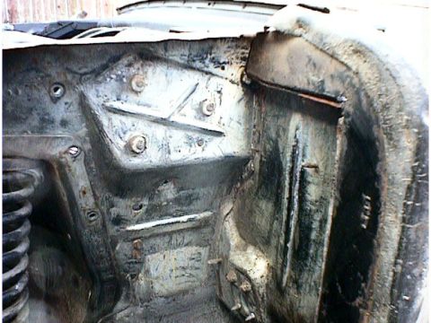1960 Ford Falcon - The image shows the corroded inner structure of a vehicle's engine bay, revealing metalwork and suspension components.
