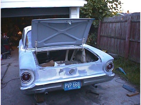 1960 Ford Falcon - Rear view of a 1960 Ford Falcon with its trunk open, showing the interior and license plate PVP 668.