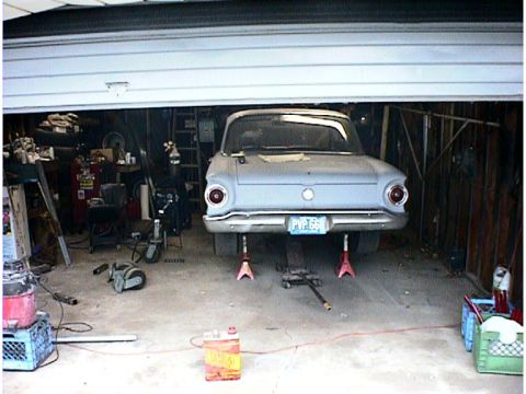 1960 Ford Falcon - This 1960 Ford Falcon is parked in a garage, raised on jack stands for maintenance.