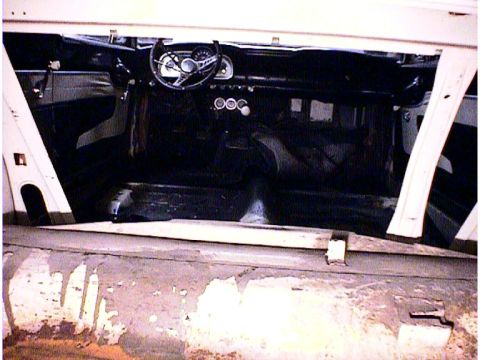 1960 Ford Falcon - The interior of a 1960 Ford Falcon shows its dashboard and seating area, with some wear visible.