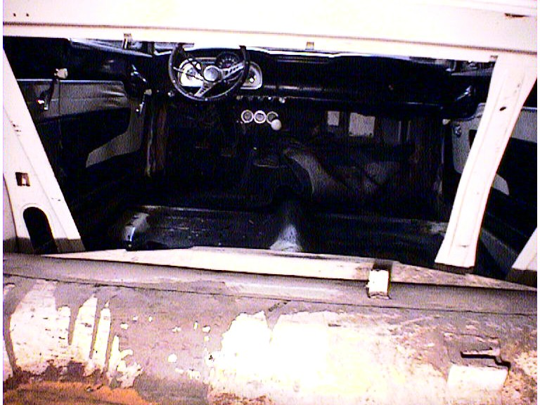 Interior view of a 1960 Ford Falcon, showing the dashboard, steering wheel, and seats