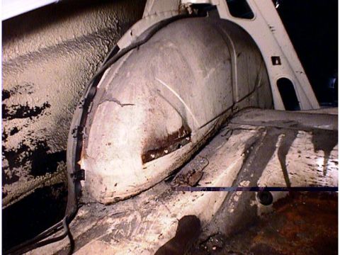 1960 Ford Falcon - The photo shows the interior of a vehicle's rear wheel well and surrounding floor pan area.