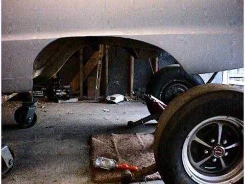 1960 Ford Falcon - Rear wheel and fender area of a vehicle, possibly undergoing maintenance or repair.