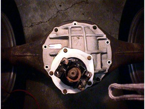 1960 Ford Falcon - The rear differential assembly is shown with a white label on its housing, and a driveshaft yoke is connected.