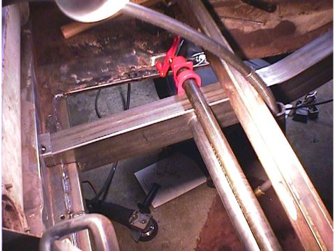 1960 Ford Falcon - Vehicle underbody undergoing repair with visible metalwork and tools.