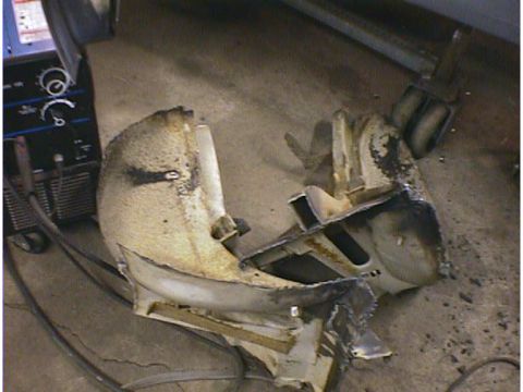 1960 Ford Falcon - Damaged car bumper parts are shown next to a welding machine.