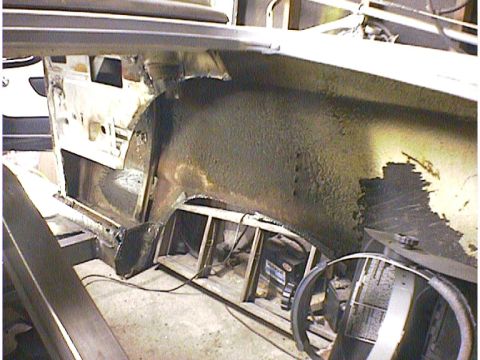 1960 Ford Falcon - Interior view of a car's rusted wheel well and floor pan, with a steering wheel and SuperMotors logo visible.