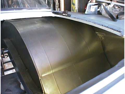 1960 Ford Falcon - Close-up of curved metal panels inside a vehicle's interior space.