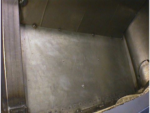 1960 Ford Falcon - Close-up view of the bare metal interior paneling, showing rivets and welding marks.
