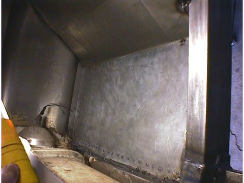 1960 Ford Falcon - Riveted metal panels are visible inside what appears to be a vehicle's cargo space.