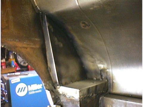1960 Ford Falcon - Unidentified vehicle frame section with visible welding work and a Miller welding machine in the background.