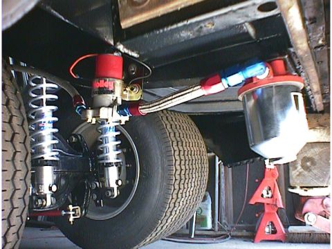 1960 Ford Falcon - Custom fuel system parts, including a Holley pump and filter, are visible under the vehicle's chassis.