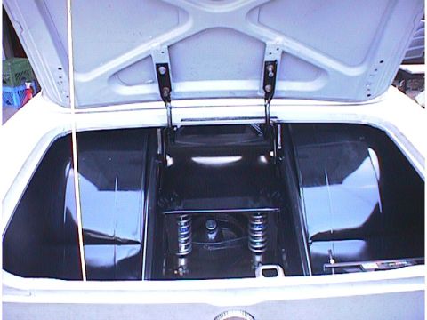 1960 Ford Falcon - The trunk of a car is open, revealing the spare tire well and rear suspension components.