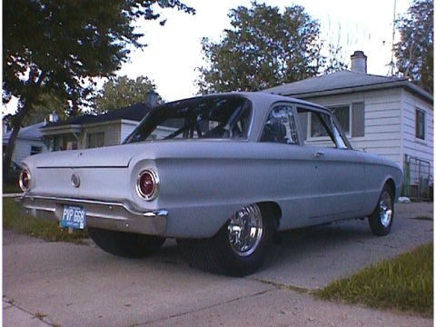 1960 Ford Falcon - Rear view of a gray 1960 Ford Falcon sedan, modified with a roll cage and aftermarket wheels.