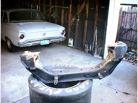 1960 Ford Falcon - Front subframe assembly removed from a 1960 Ford Falcon, which is visible in the background.