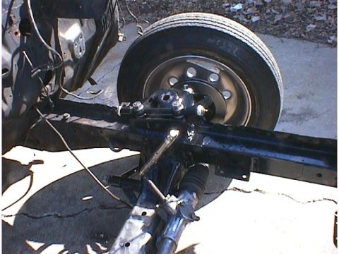 1960 Ford Falcon - This image shows a portion of a vehicle's chassis, including the front wheel and suspension system.
