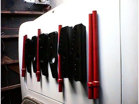 1960 Ford Falcon - Close-up view of black and red automotive parts attached to a white panel.