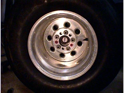 1960 Ford Falcon - A close-up view of a custom aluminum wheel and tire assembly, with visible text from Supermotors.net.