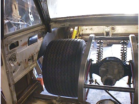 1960 Ford Falcon - Custom rear suspension and large tire assembly visible within a vehicle's frame.