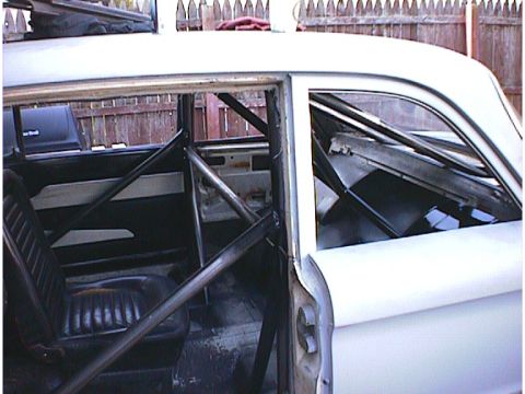 1960 Ford Falcon - Interior view of a 1960 Ford Falcon showing a custom roll cage installation.