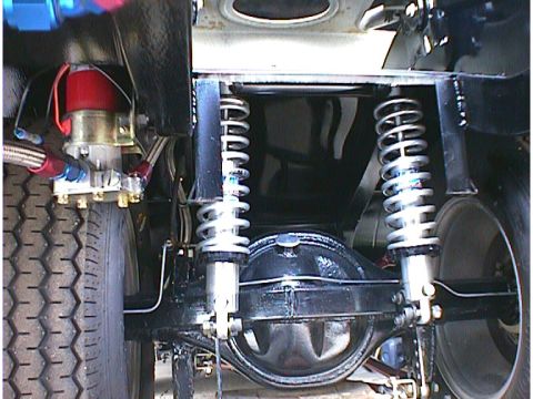 1960 Ford Falcon - This image shows the rear suspension and axle assembly of a vehicle, including shock absorbers and a differential housing.